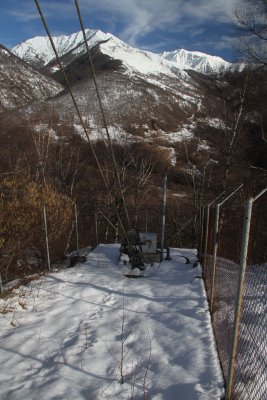 Long guy wires are directly grounded. Obstruction lights power connection and UV sensor on the background (red device on a pole).