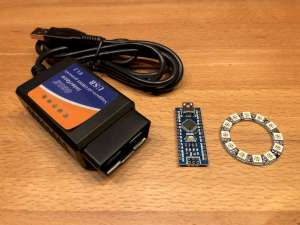 The three main parts of this gauge: the OBD-II to USB converter (left), an Arduino Nano or compatible microcontroller board (center) and a 12-LED Neopixel ring (right). (click to enlarge)